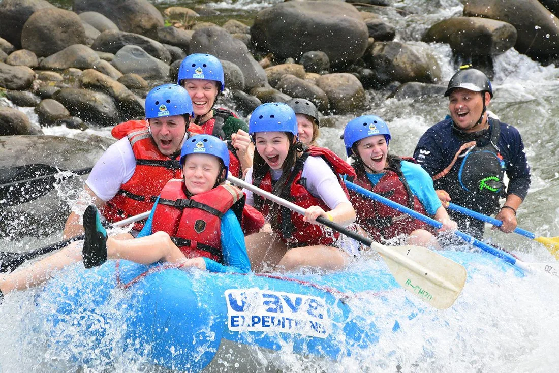 Family rafting together on a Costa Rica river with a local guide