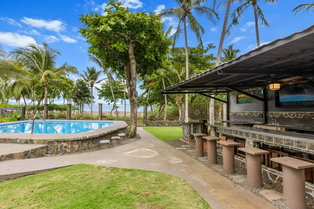 Beachfront palapa bar and pool at a luxury vacation villa in Jaco, Costa Rica