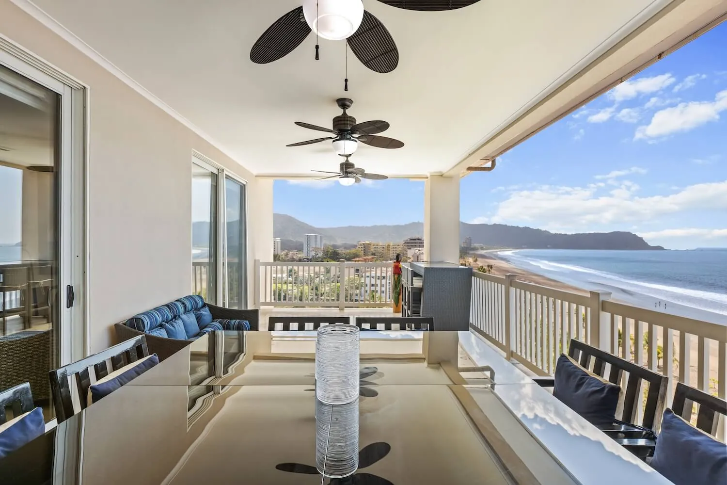 Penthouse balcony at The Palms 1002 with dining table and Jaco Beach below