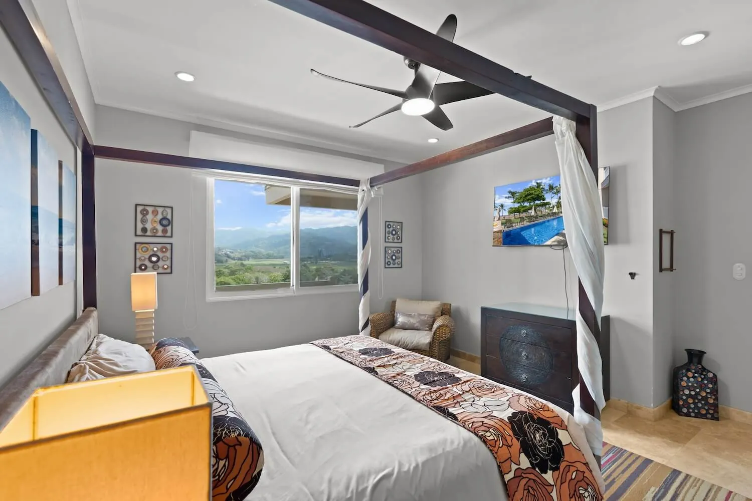 Second bedroom with canopy king bed at The Palms 1002