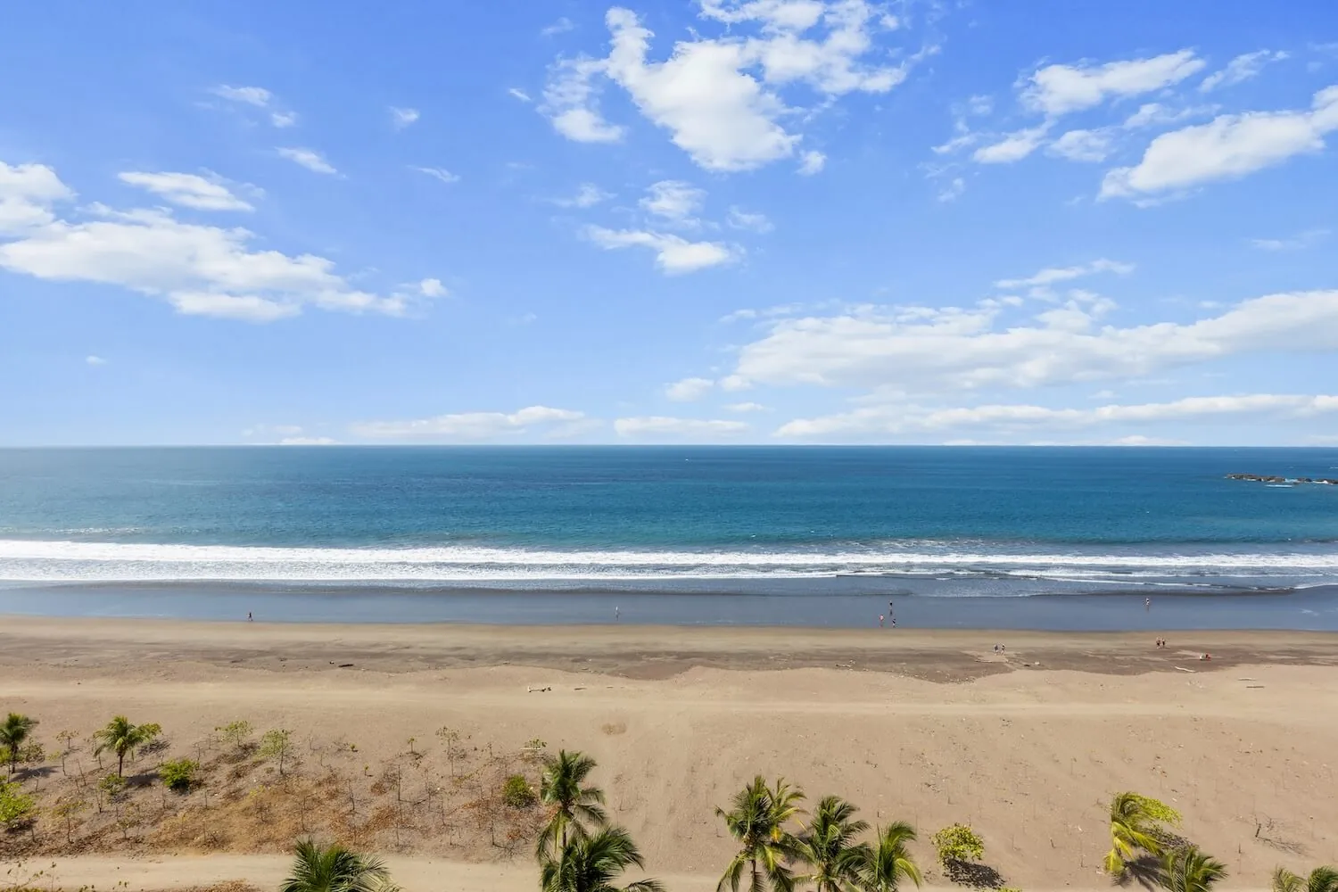 Jaco Beach and the Pacific Ocean seen from a top-floor balcony at The Palms