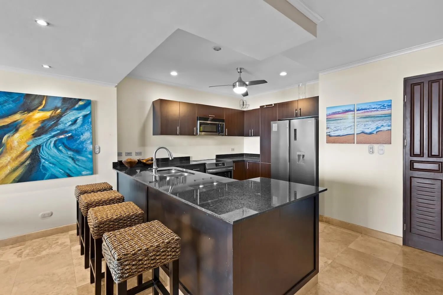 Kitchen breakfast bar with stools and stainless steel appliances