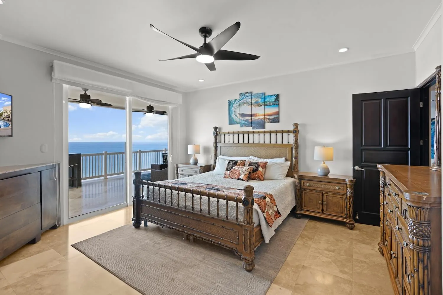 Primary bedroom with king bed and balcony doors at The Palms 1002