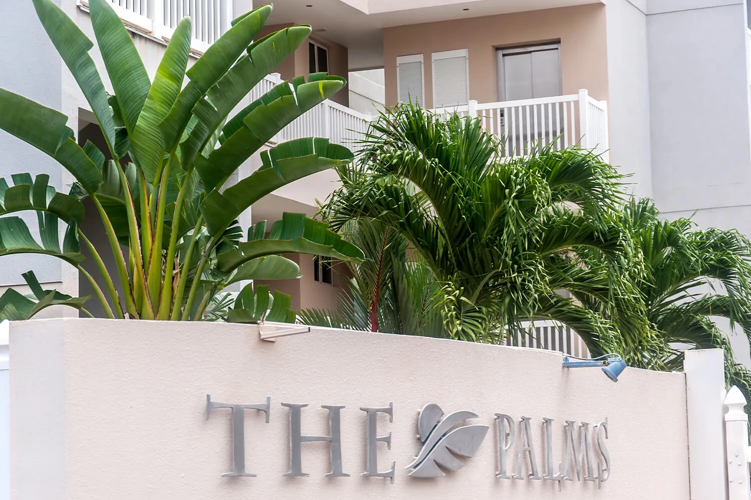 Entrance sign of The Palms condominiums in Jaco Beach, Costa Rica