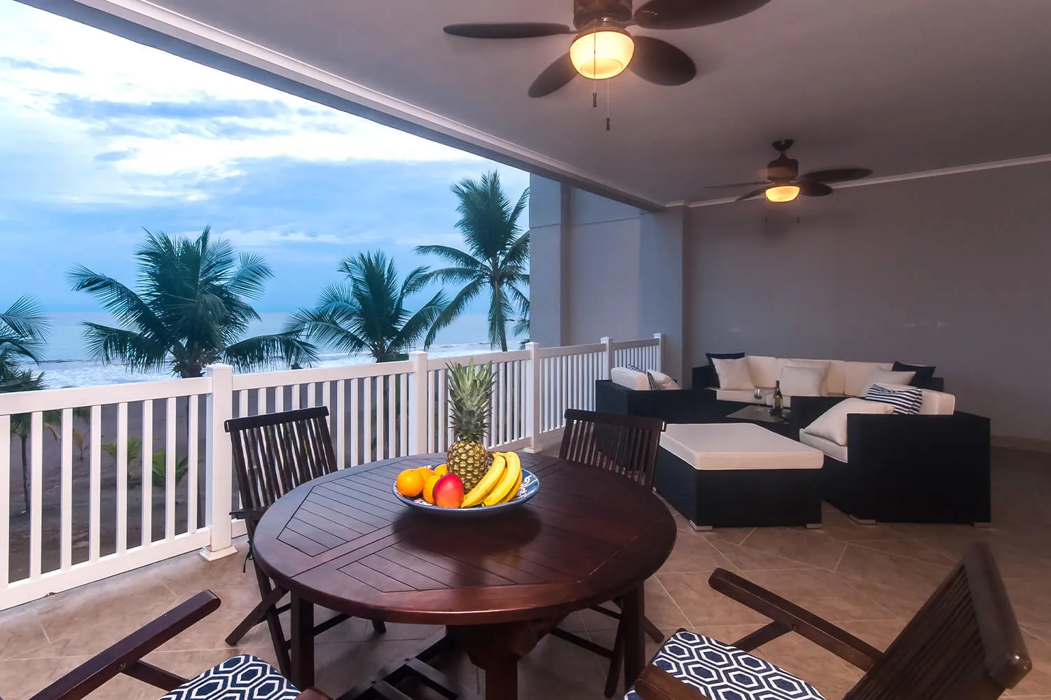 Lounge set and dining table on the balcony of The Palms 402