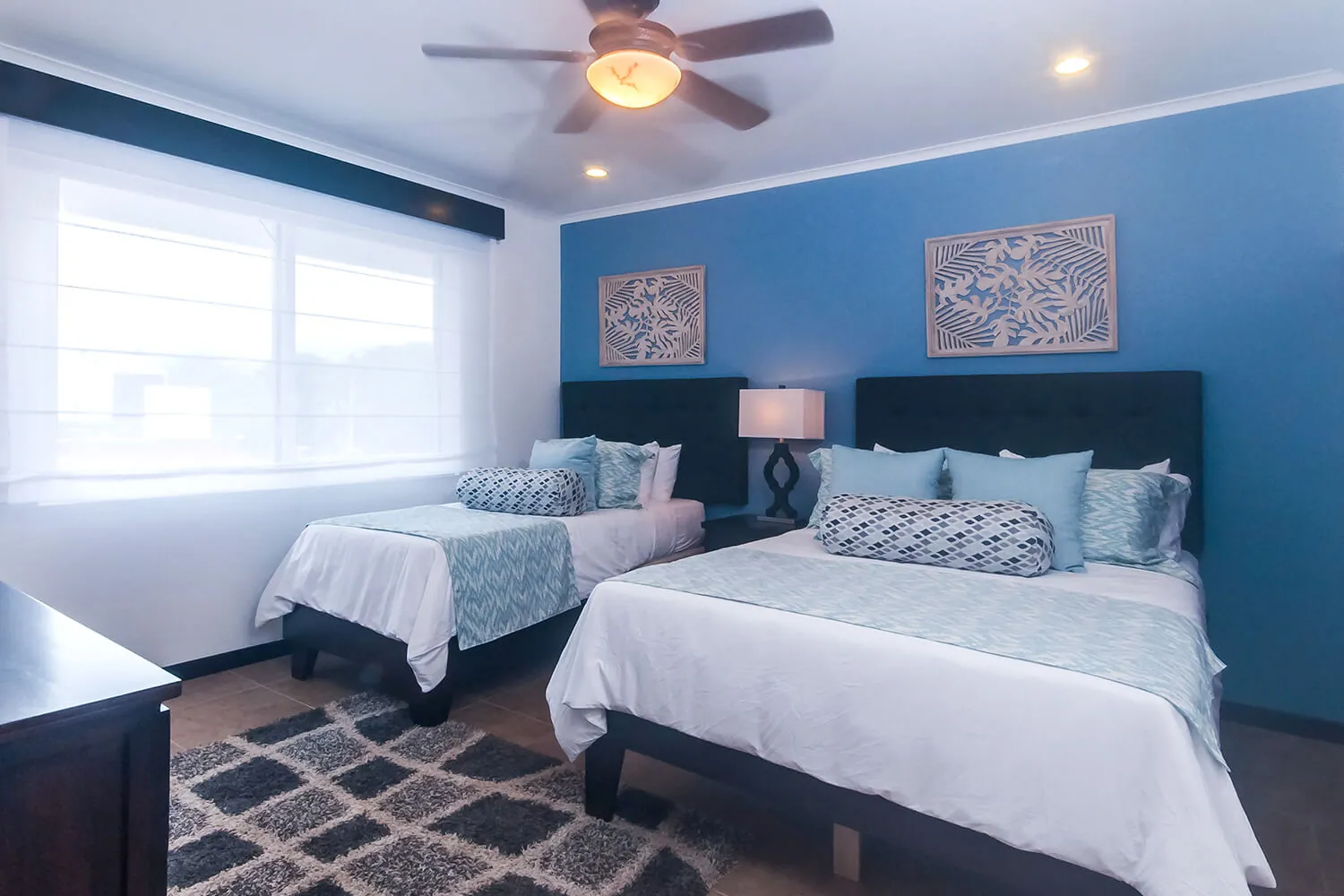 Second bedroom at The Palms 402 with a queen bed and a single bed