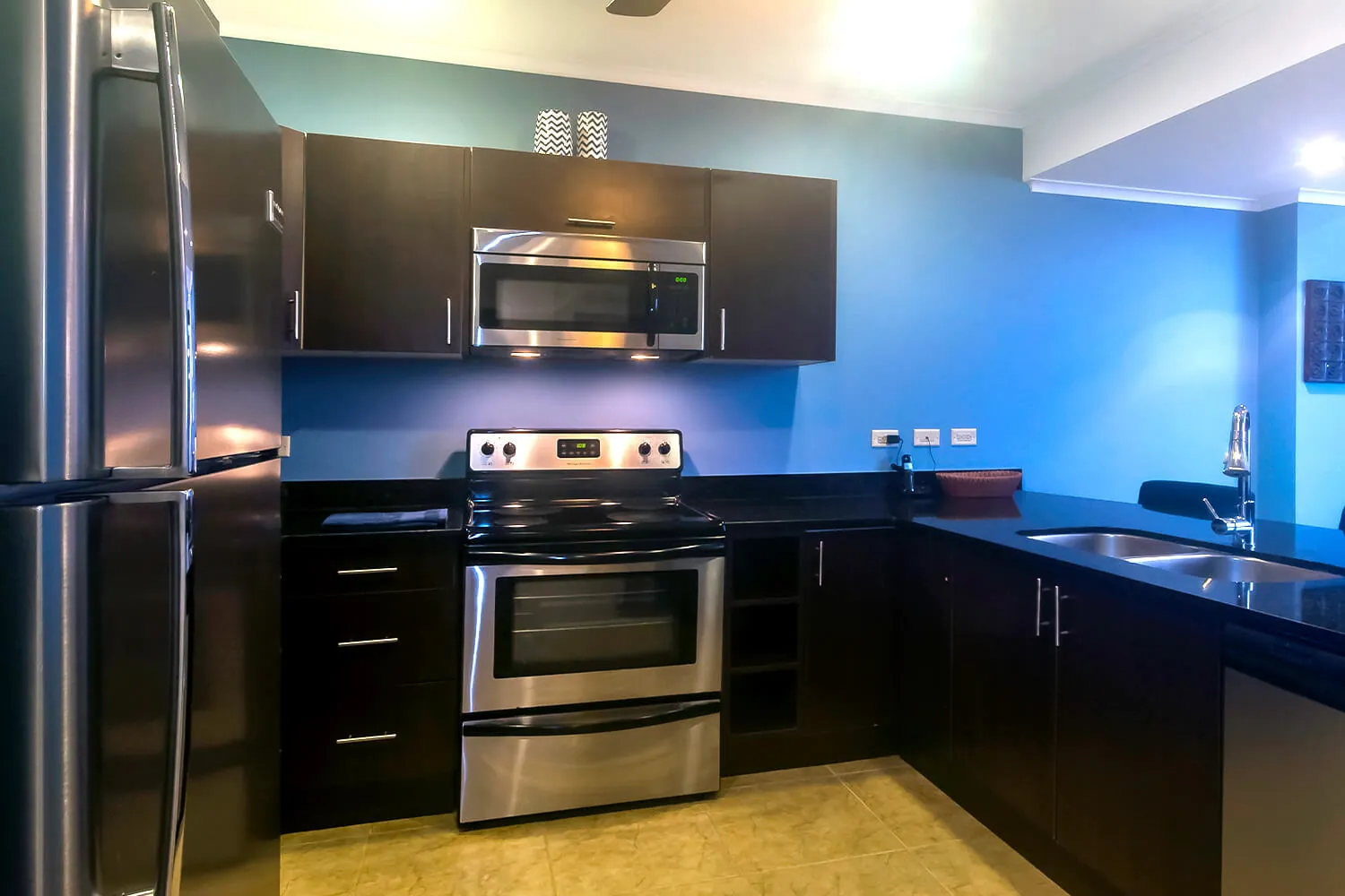 Kitchen with stainless appliances at The Palms 402