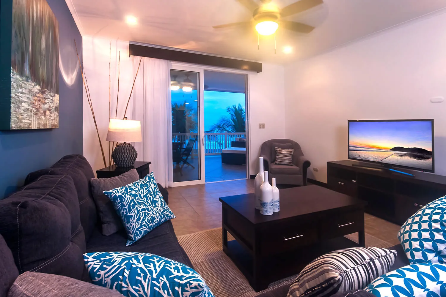 Living room with blue accents at The Palms 402