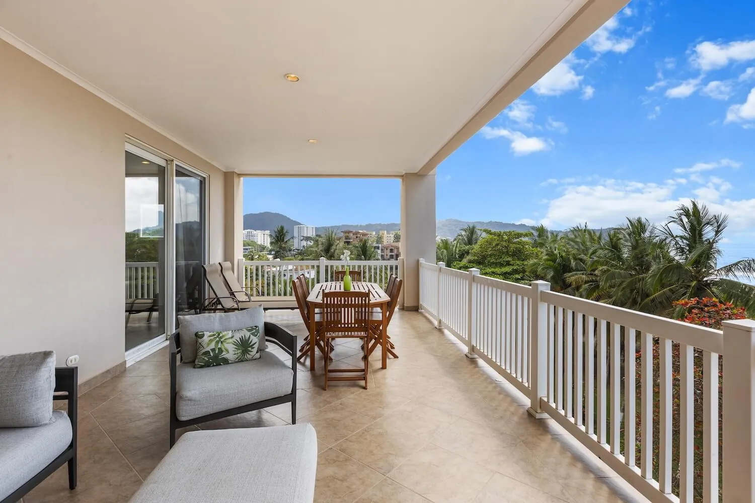 Covered balcony with dining table at The Palms 504