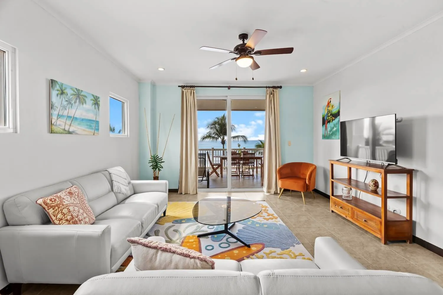 White sofas and balcony doors at The Palms 504