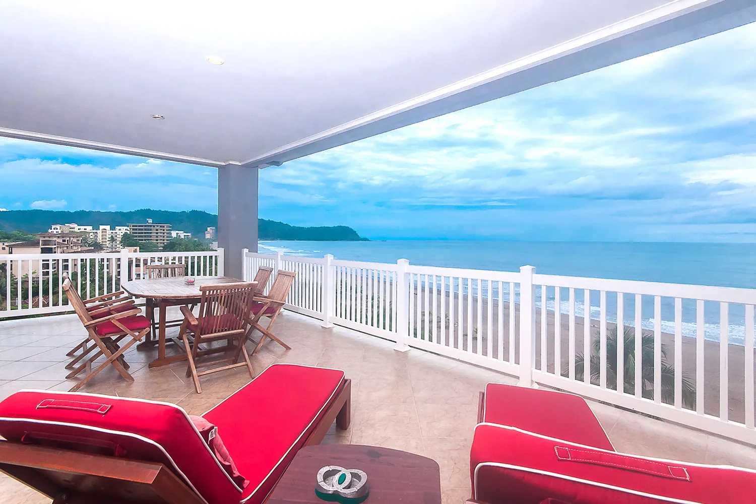 Red loungers and dining set on the seventh-floor balcony