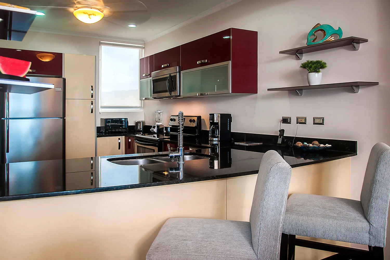 Modern kitchen with red cabinets at The Palms 704
