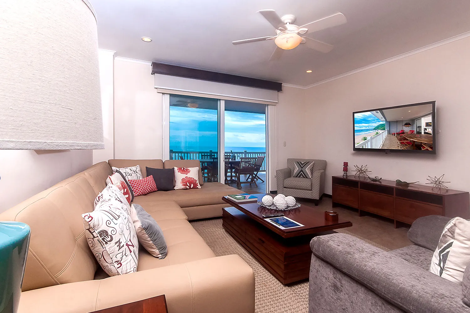 Sectional sofa and view to the balcony at The Palms 704
