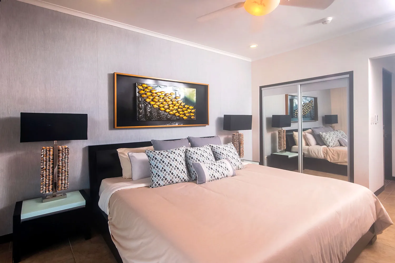 Primary bedroom with king bed at The Palms 704