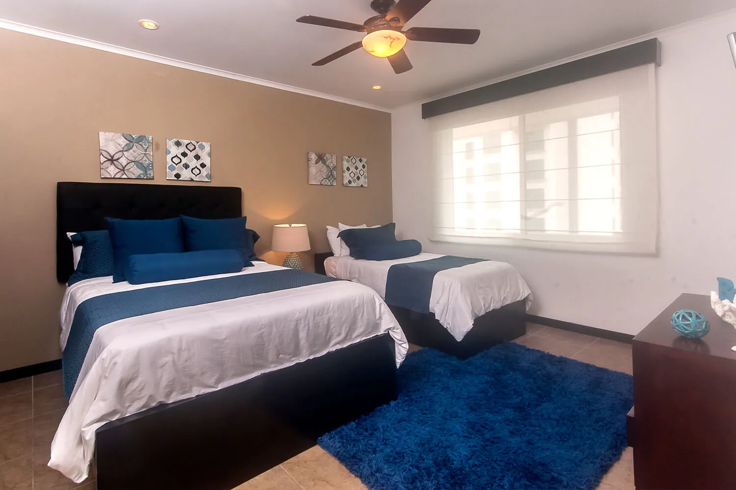 Second bedroom at The Palms 902 with a queen bed and a single bed