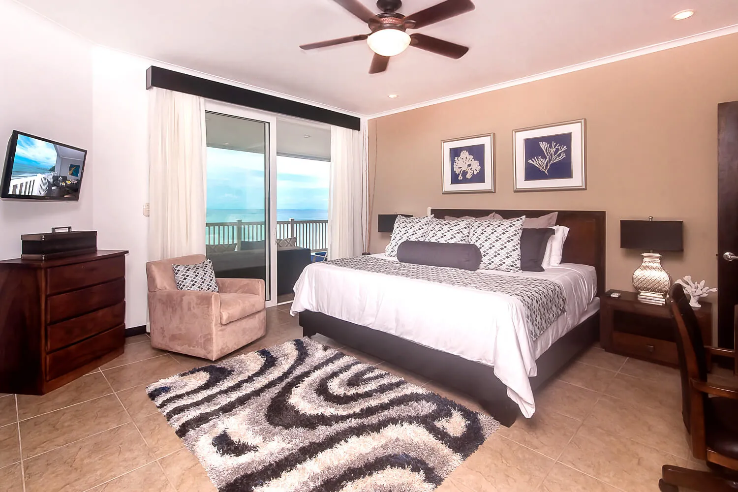 Primary bedroom at The Palms 902 with king bed and ocean view
