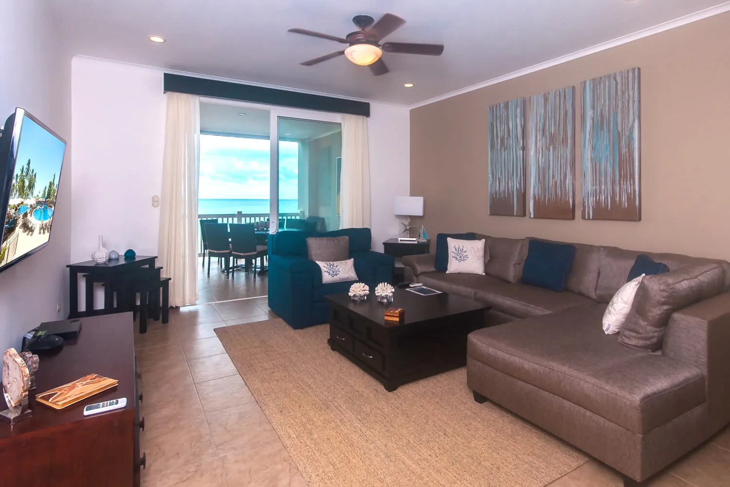 Living room at The Palms 902 with sectional sofa and sliding doors to the ocean