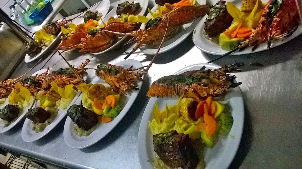 Plated seafood dishes prepared by a private catering team